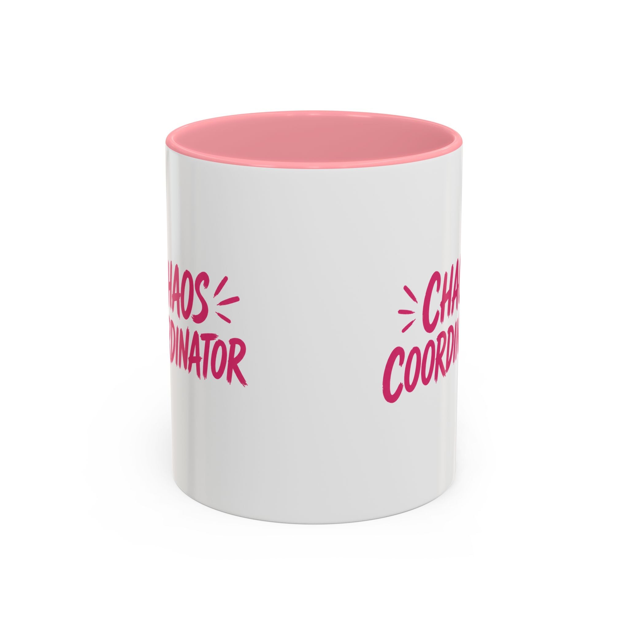 White coffee mug with pink interior featuring bold pink Chaos Coordinator text design