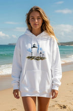 Woman wearing a white hoodie with a lighthouse design on a beach